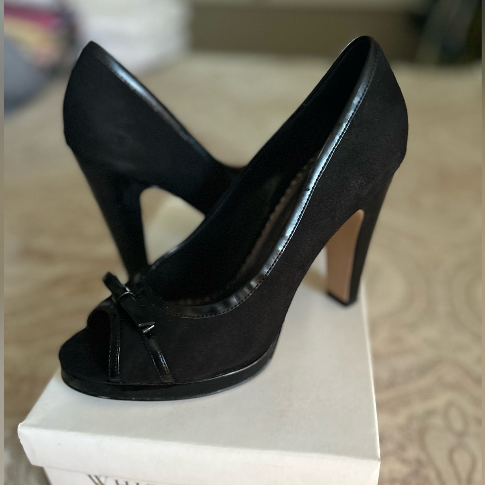 Black peep toe heel with bow detail. Worn once. Mint condition. Size 8.